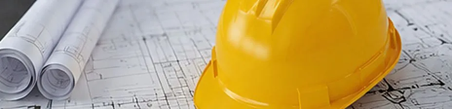 Casco da cantiere su tavole di progetto